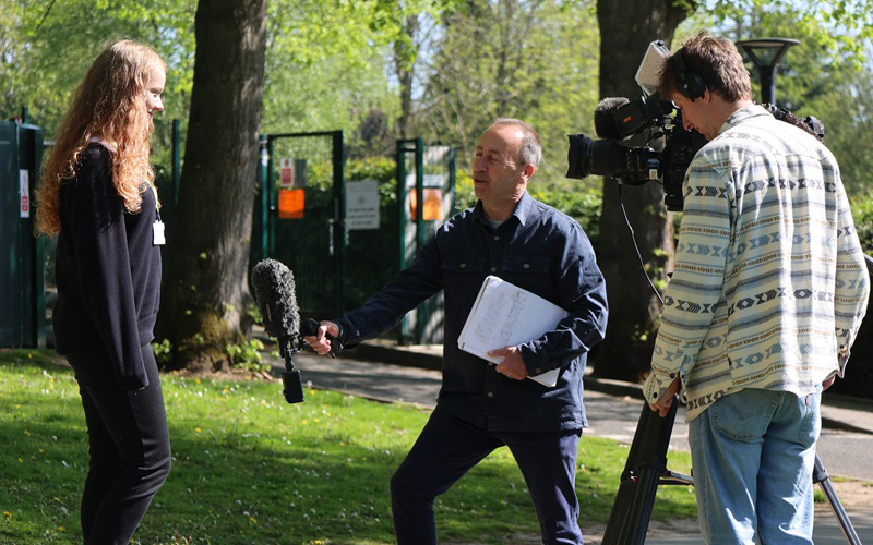 student and a camera